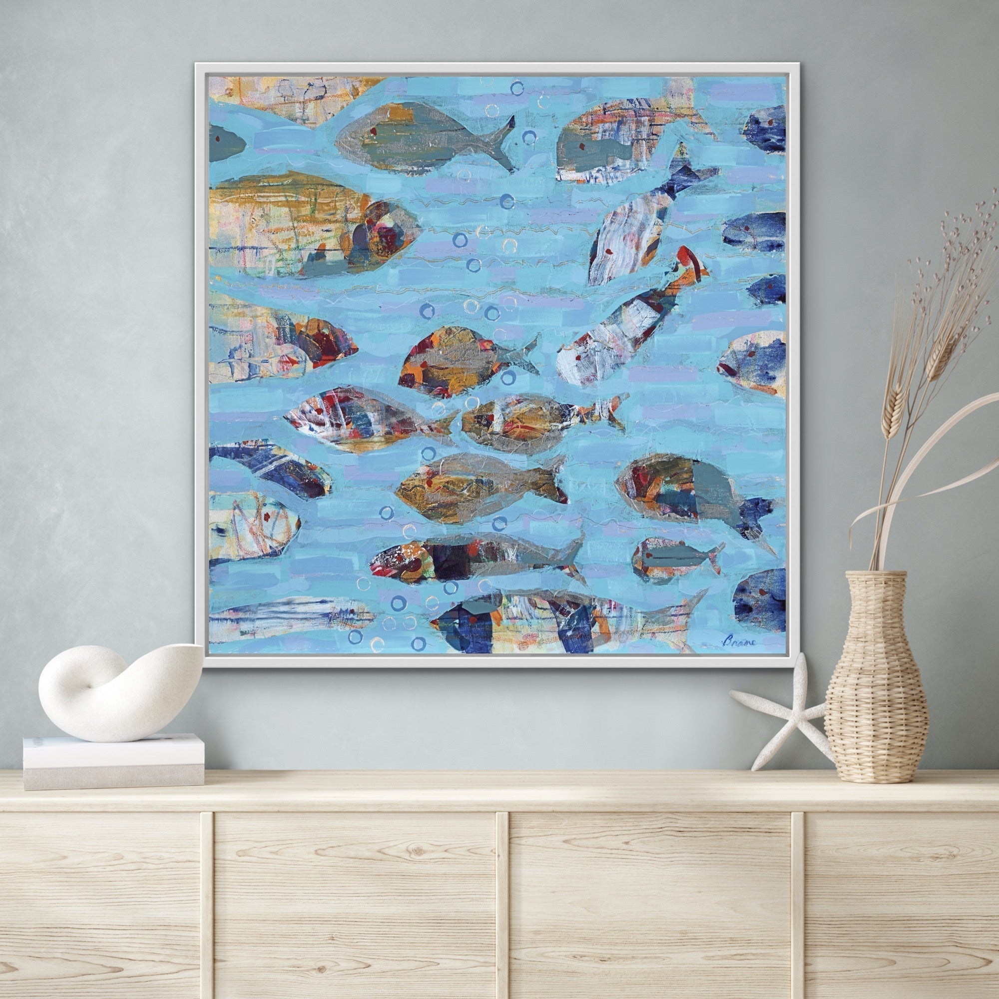 coastal modern fish painting on wall above cabinet