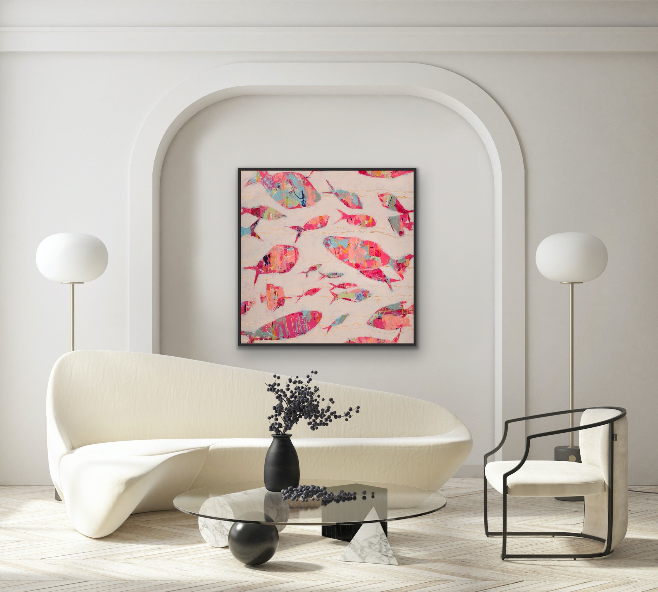 Modern living room with a contemporary coastal canvas print with bright, collage-style fish painting on the wall, white sofa, and glass coffee table.