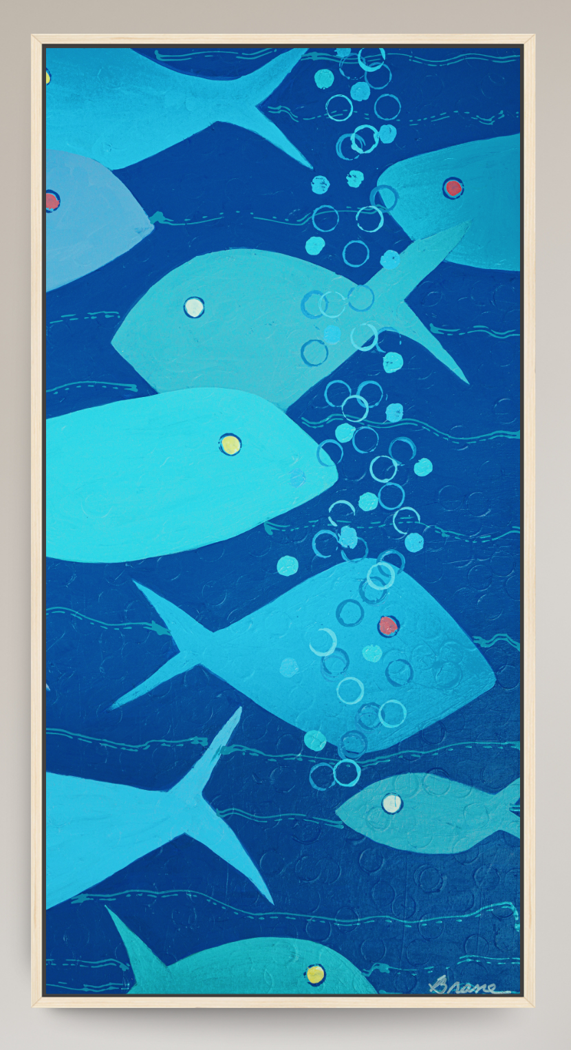 A framed abstract art print featuring stylized blue and turquoise fish swimming upwards with bubble lines on a deep blue background, enclosed in a light wood frame.