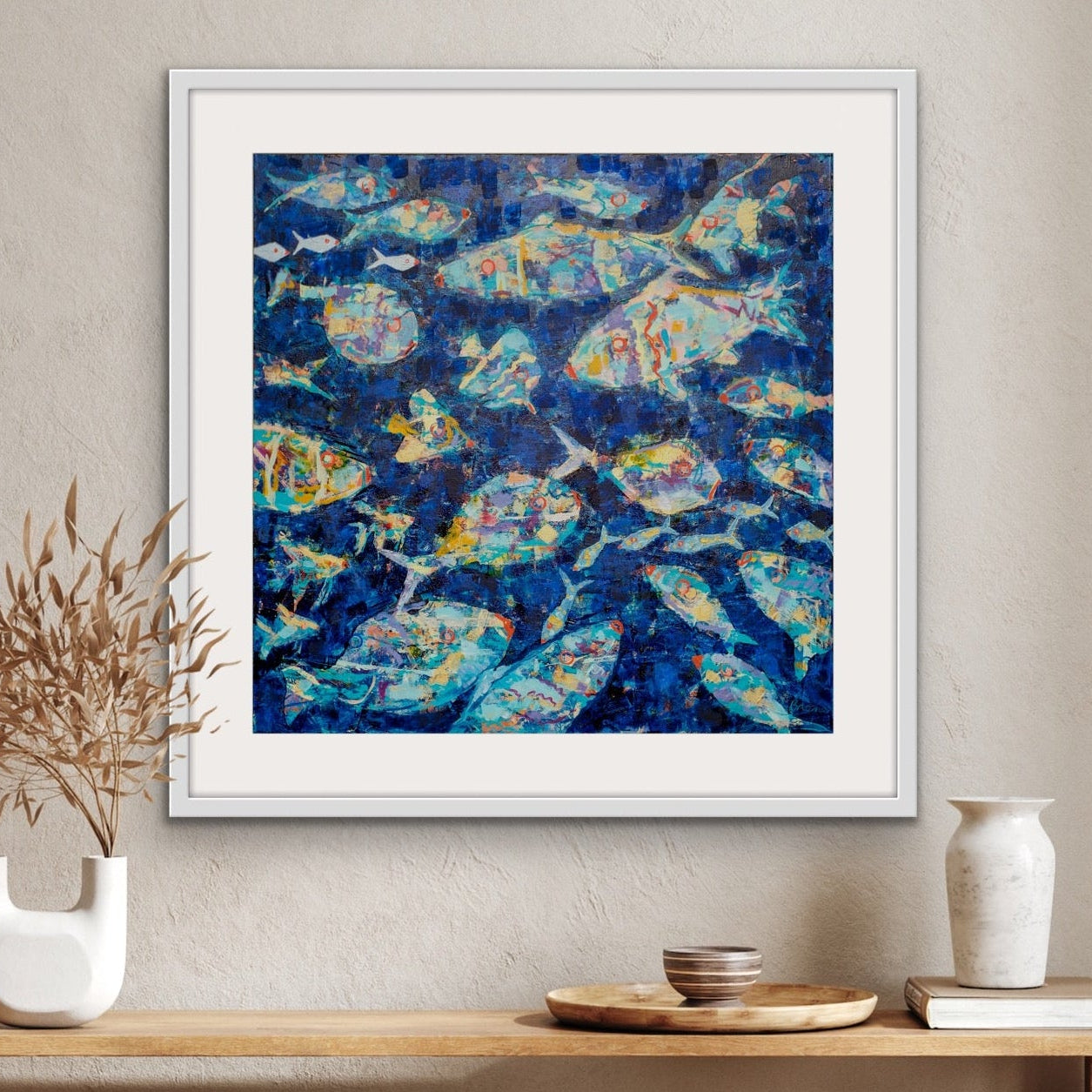 Underwater Wonderland abstract fish artwork on cotton rag paper on a wall above a wooden console table with decorations