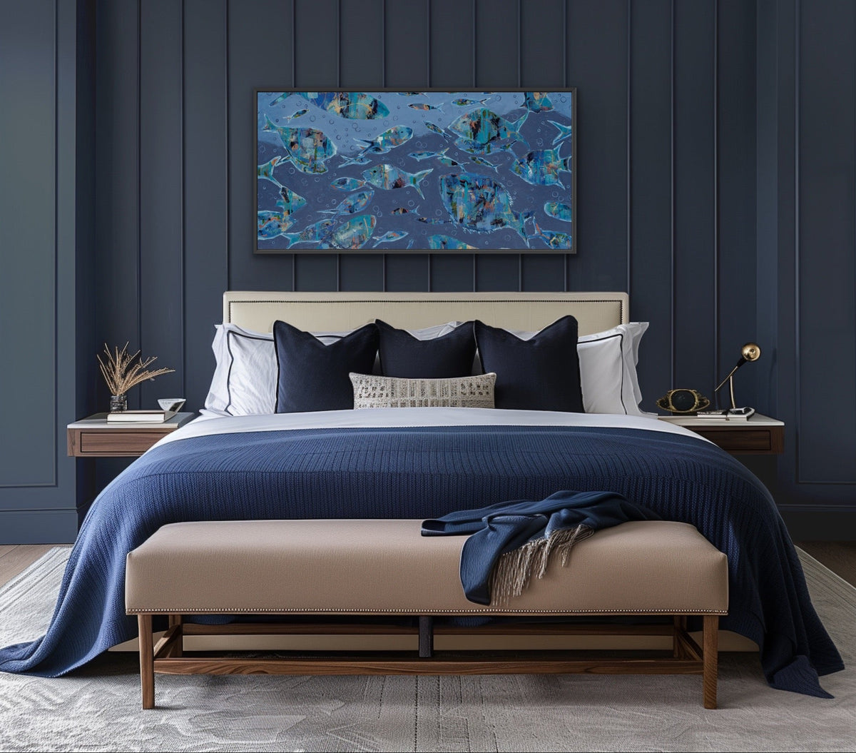A modern bedroom featuring a dark navy blue paneled accent wall with a colorful abstract canvas print above a bed. The bed is styled with navy blue, black, and white bedding, a beige upholstered bench at the foot, and matching bedside tables.