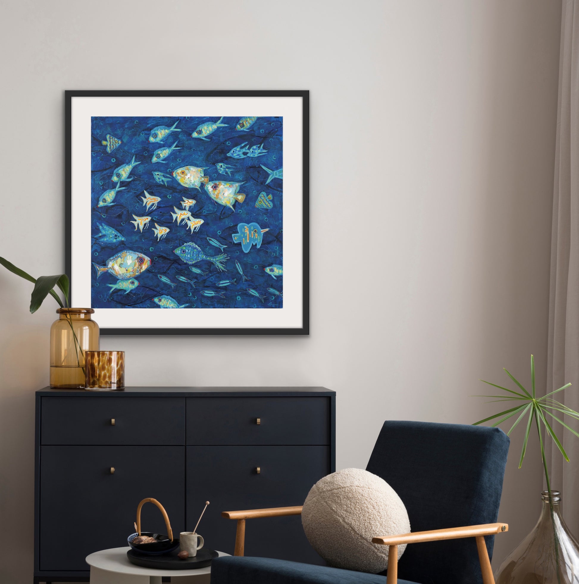 Luxury framed coastal fish print for modern beach home décor above ablack cabinet.