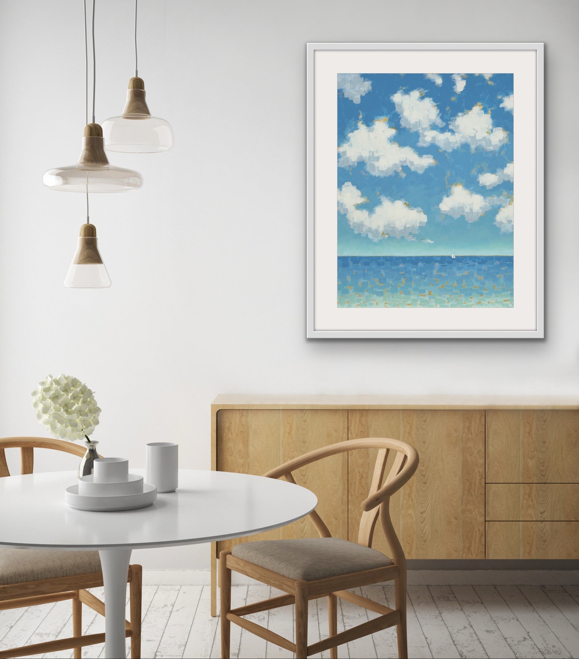 Far and Free vertical cotton rag seascape framed artwork of a beach scene with blue sky and clouds in a modern interior setting.