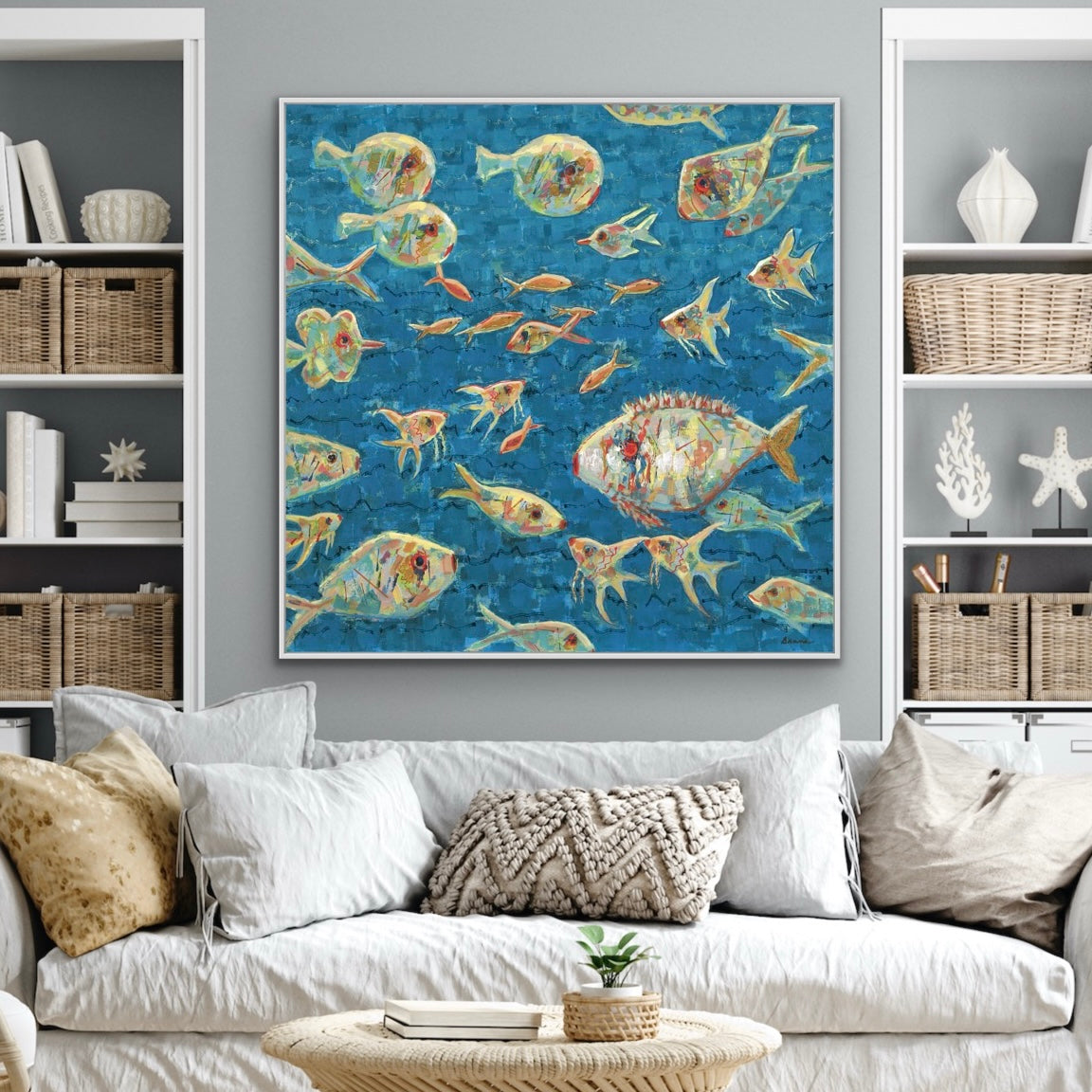 Living room with a colorful abstract ocean fish painting on the wall, white sofa, and shelves with decorative items.