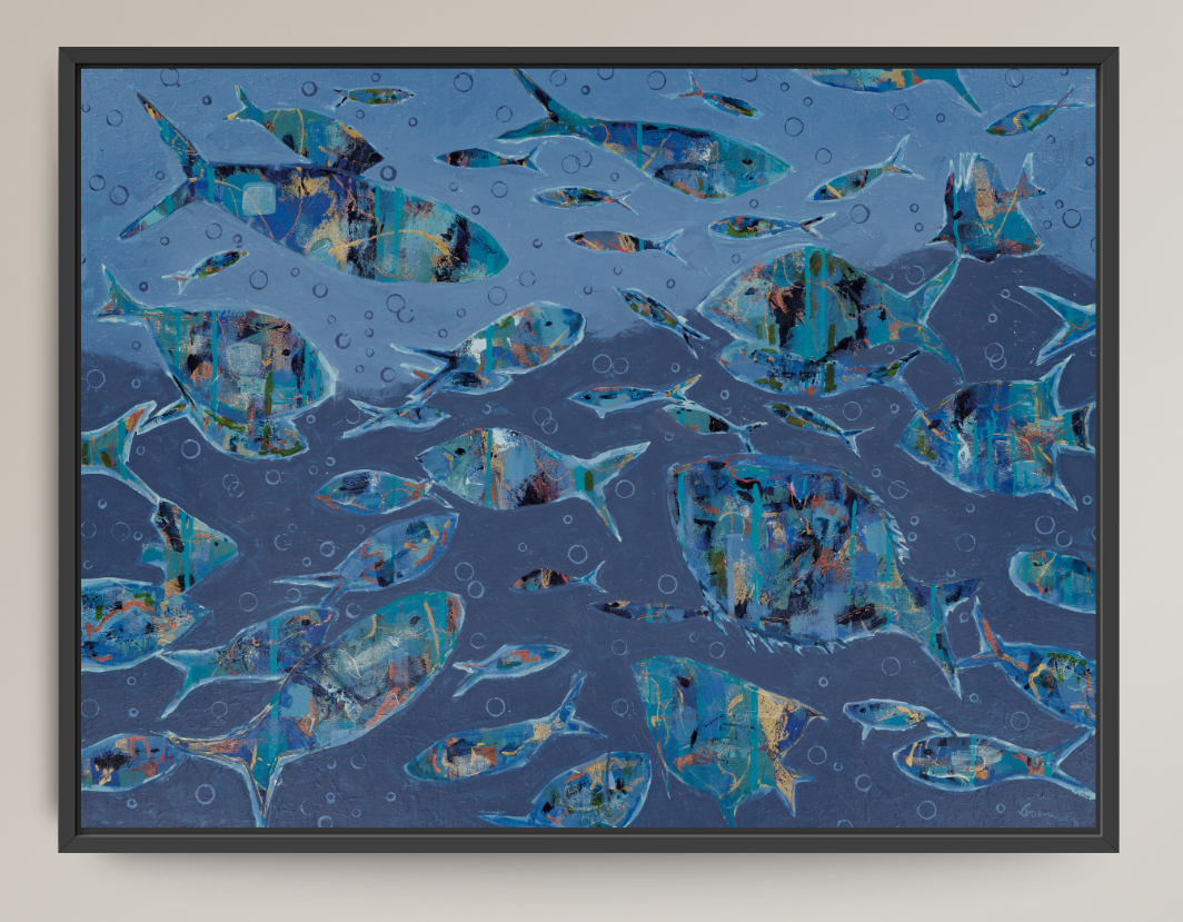 Framed wall art featuring an underwater-style scene with multiple blue fish swimming across a textured blue background, shown against a light neutral wall.