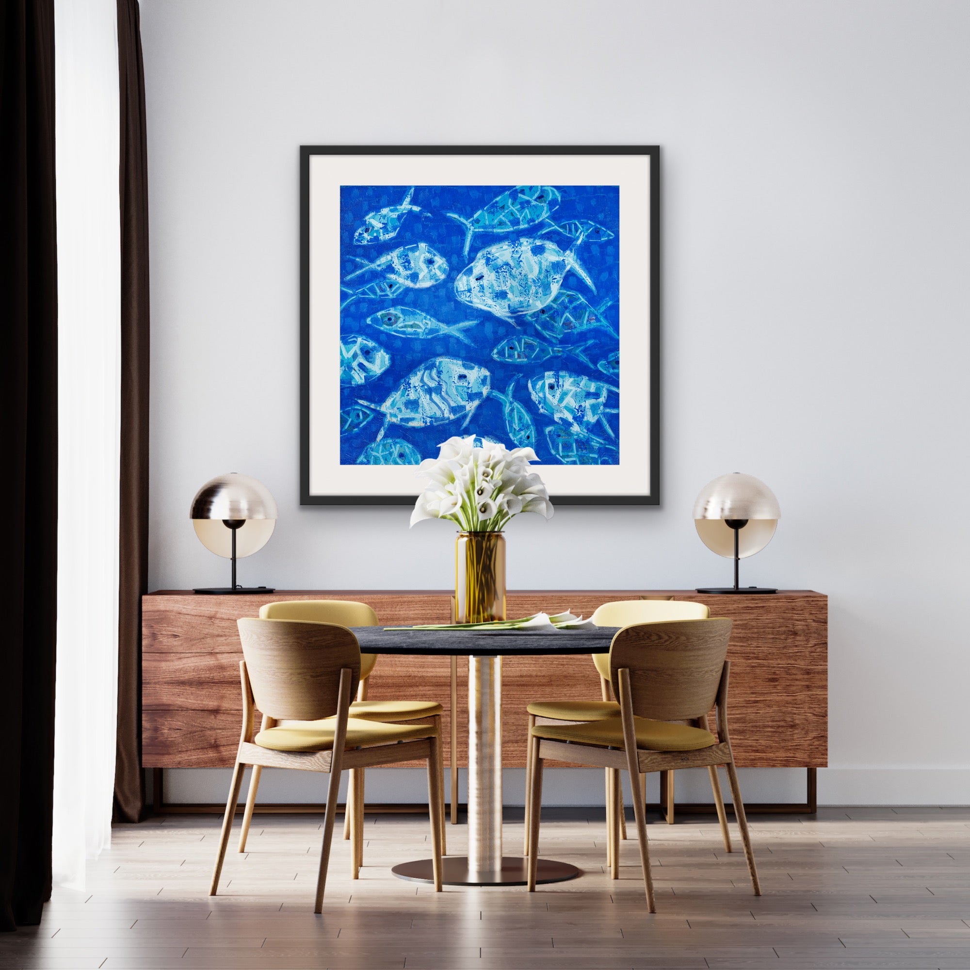 Dining room with a luxury cotton rag giclée of blue fish composition on the wall, wooden table, and chairs.