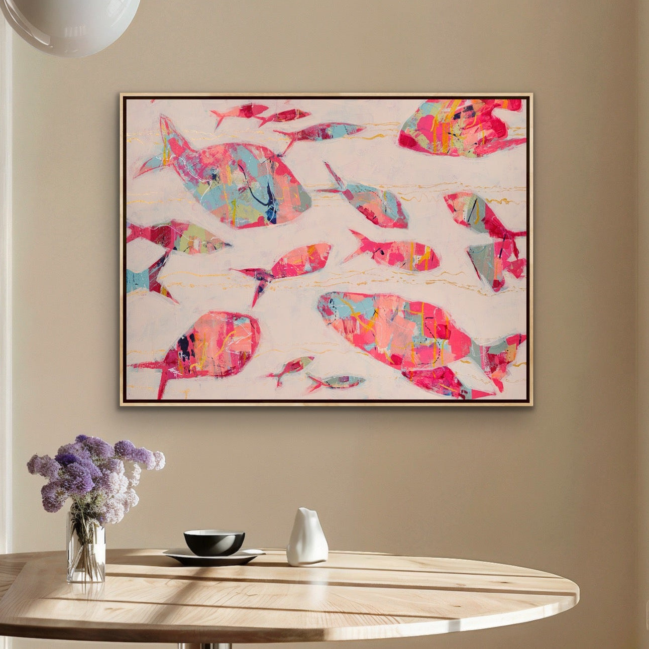 Dining room with a round table, stools, and a Contemporary coastal fish artwork on canvas in warm pink and blush tones on the wall.