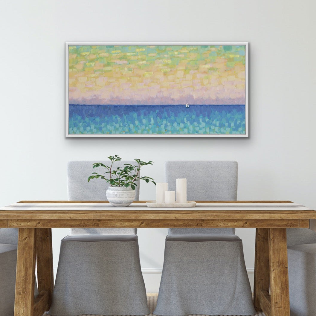 Dining room with wooden table and gray chairs, featuring a horizontal seascape artwork featuring pastel sky and calm blue ocean painting on the wall.