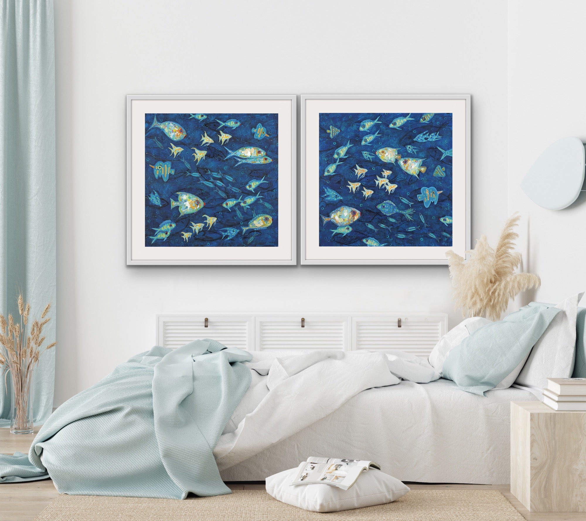 Two-panel coastal marine artwork matted and framed for designer interiors on a wall above a bed in a bedroom.