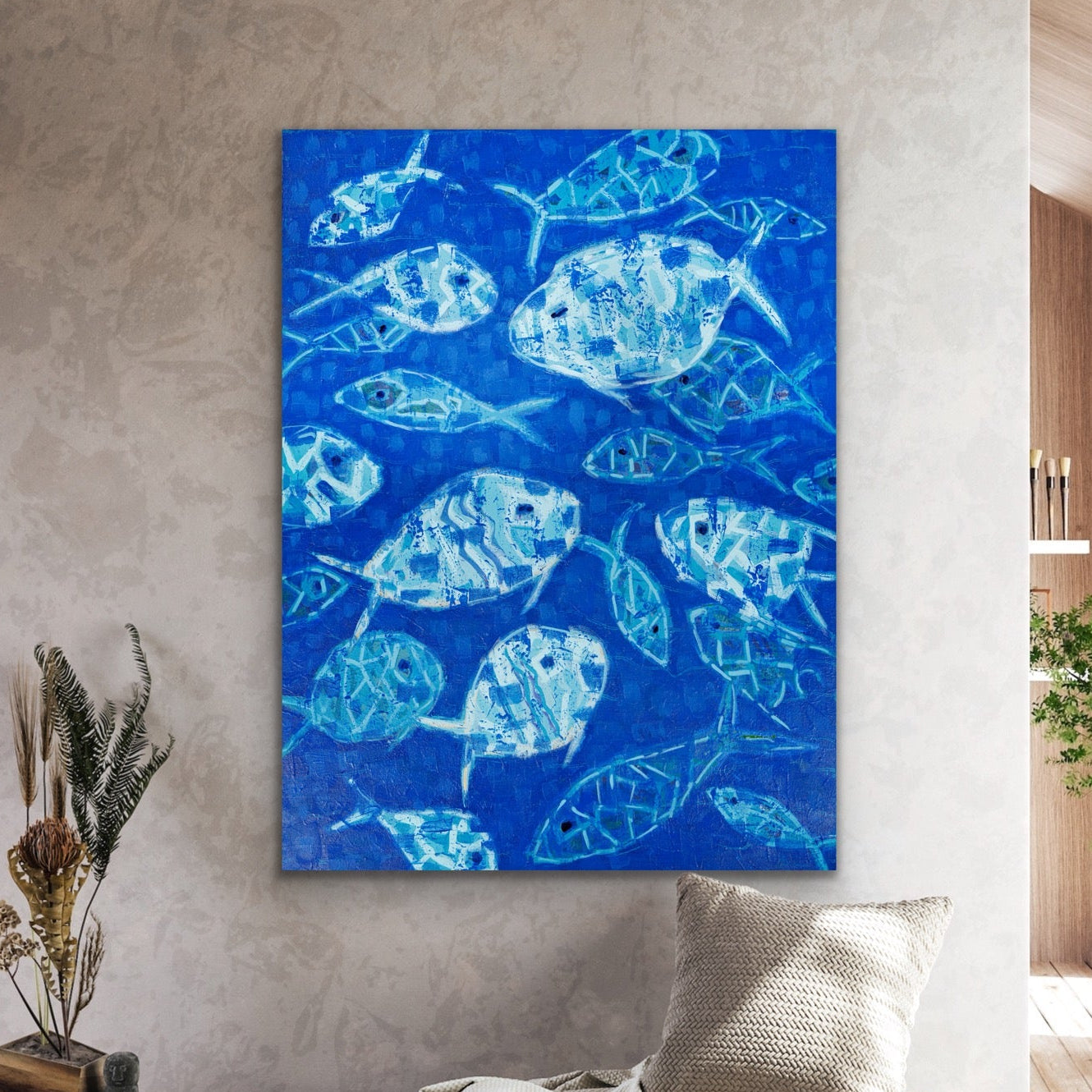 Blue abstract fish painting on a wall in a modern living room.