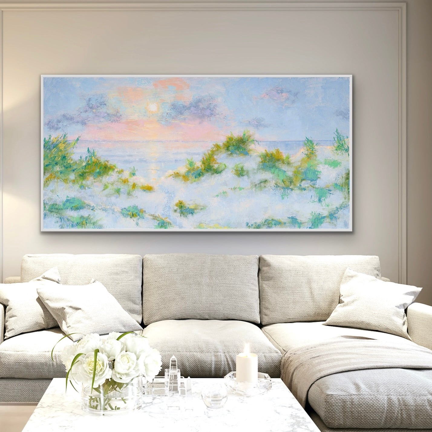 Living room with a extra large coastal sunrise painting above a sofa