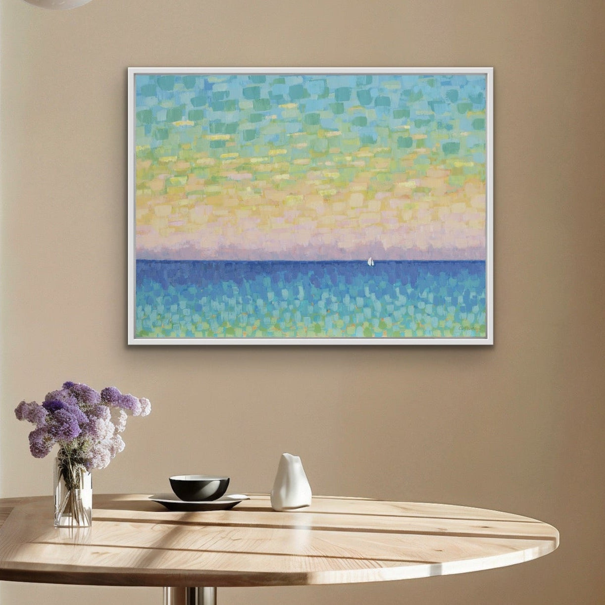 Dining room with a round wooden table, stools, and a coastal sunset wall art in soft pastel colors on the wall