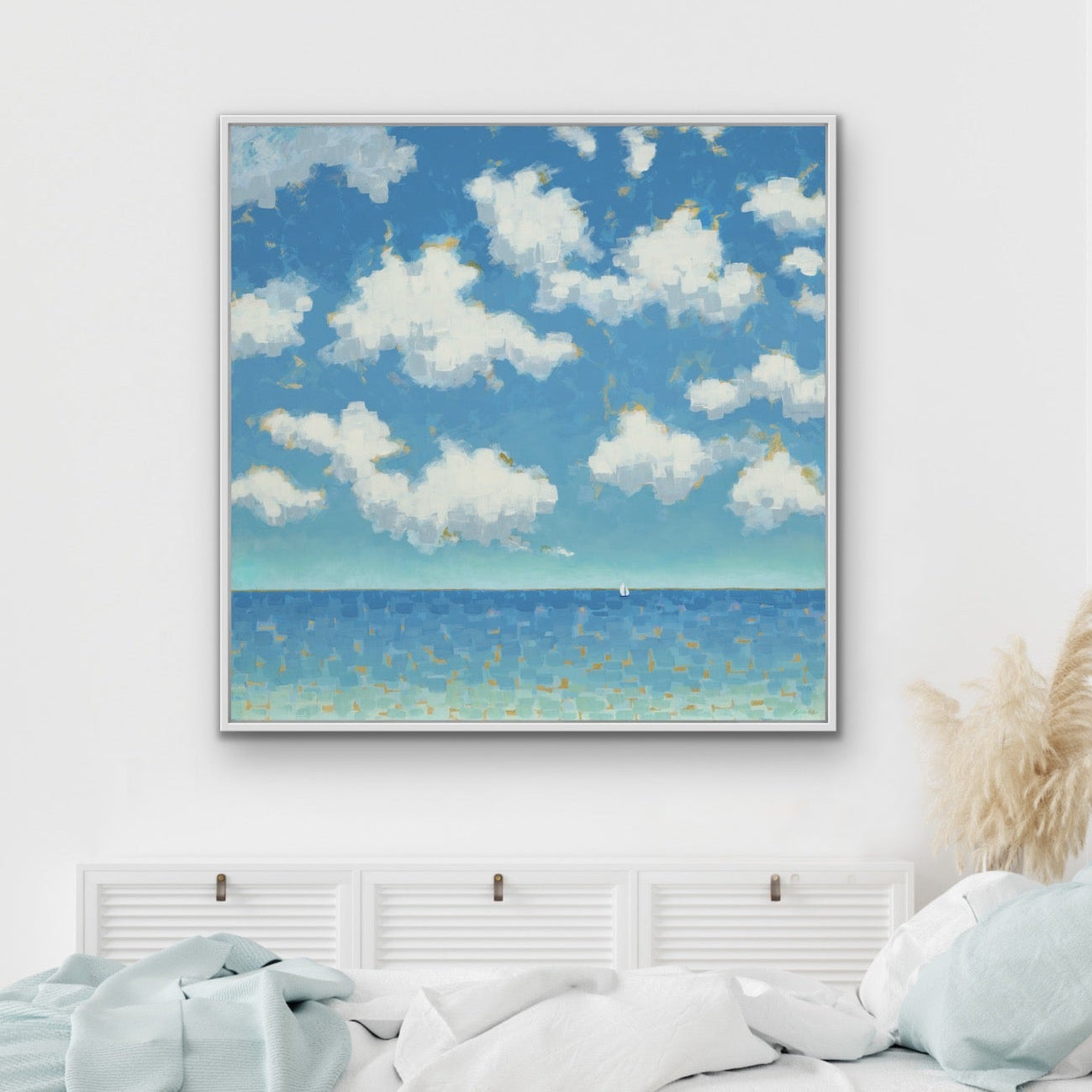 Bedroom with a large framed artwork of a small sailboat near the horizon in Far and Free, symbolizing freedom above a bed.
