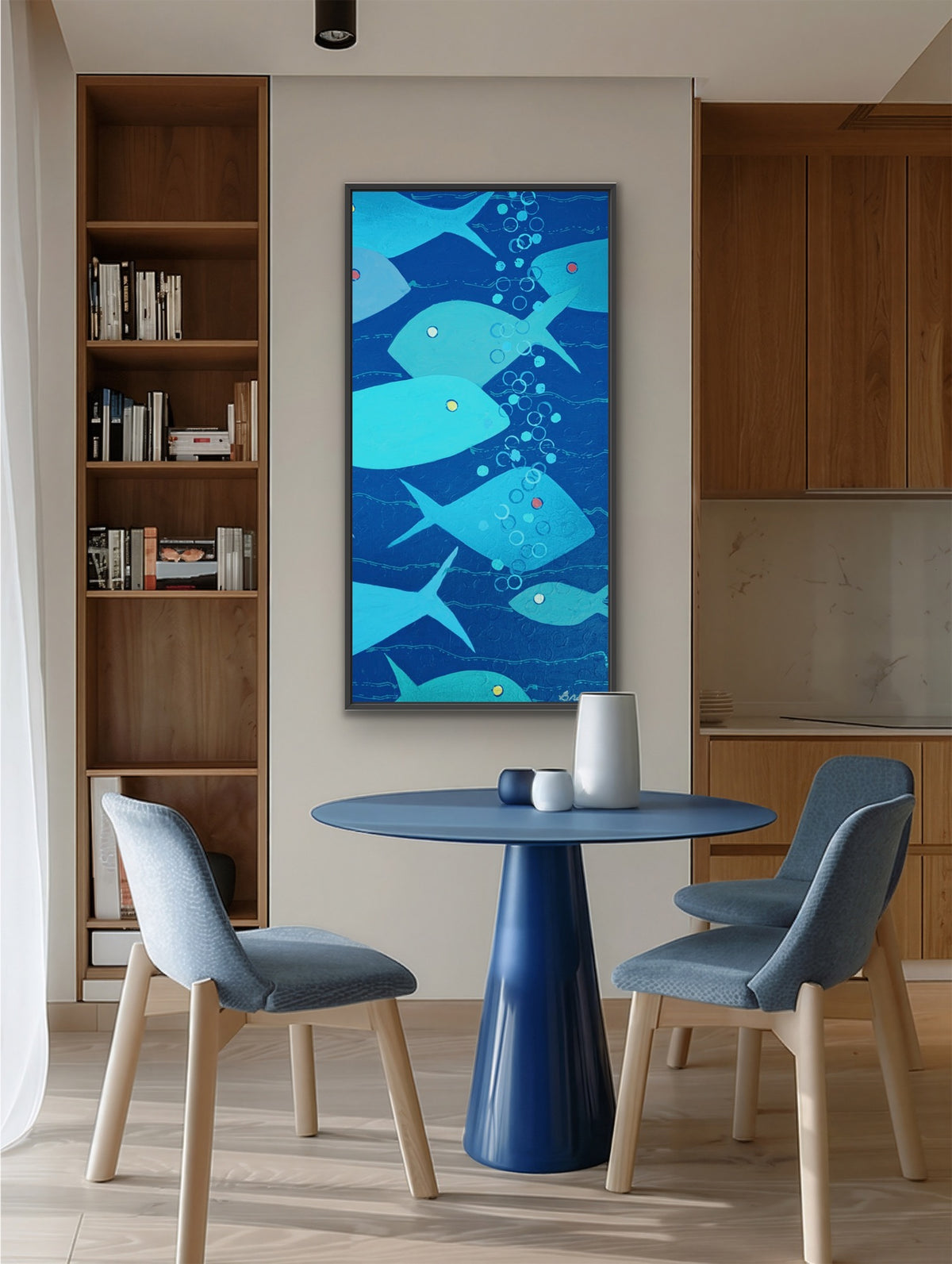 A vertical canvas wall art print featuring a whimsical blue and teal whale illustration, displayed in a modern dining room setting above a blue table and chairs.