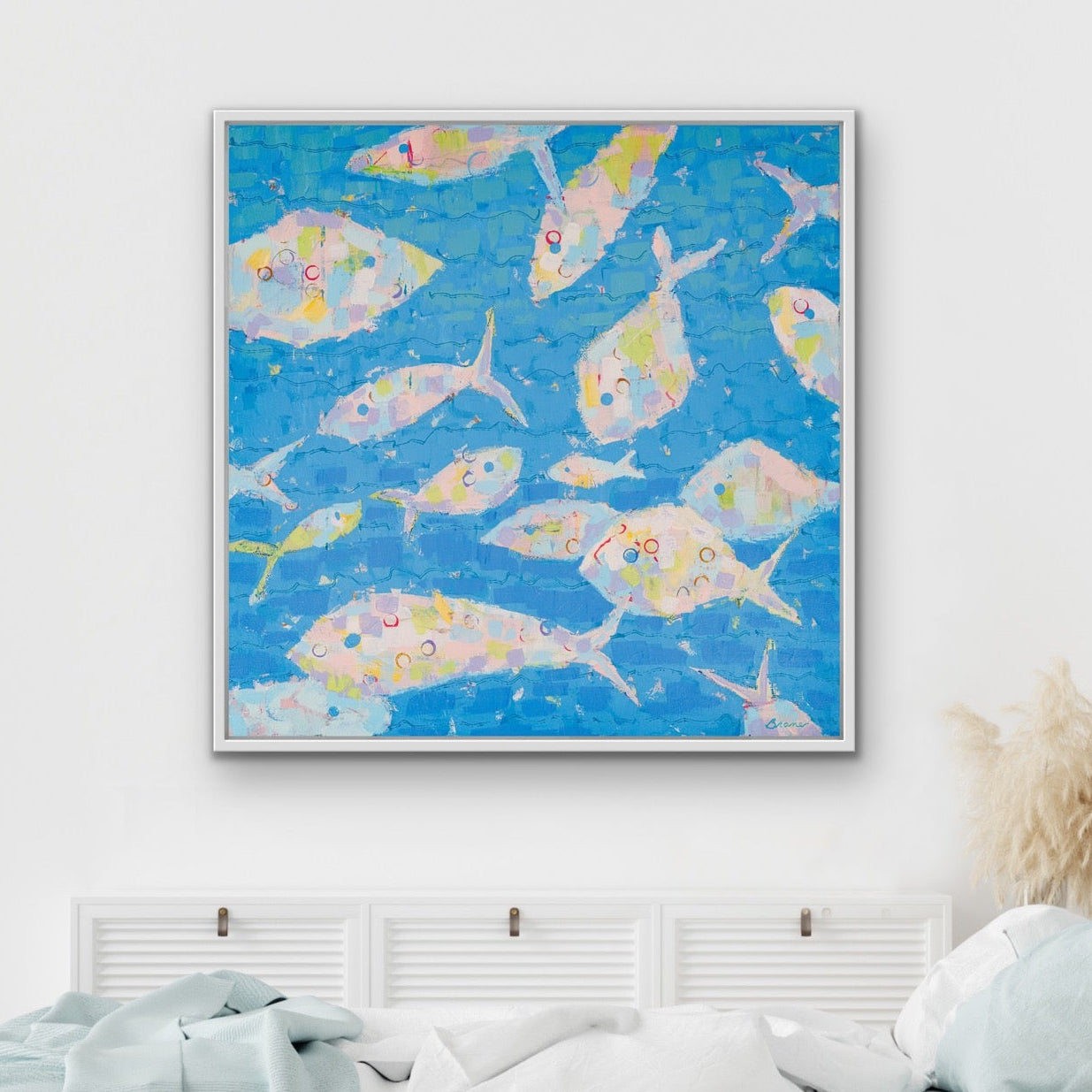 Bedroom with a contemporary coastal décor featuring colorful abstract fish painting on the wall