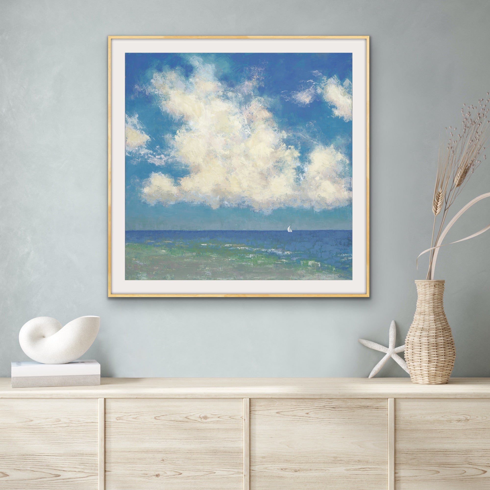 Just like you are at the beach a sunny cloud filled seascape with a sailboat