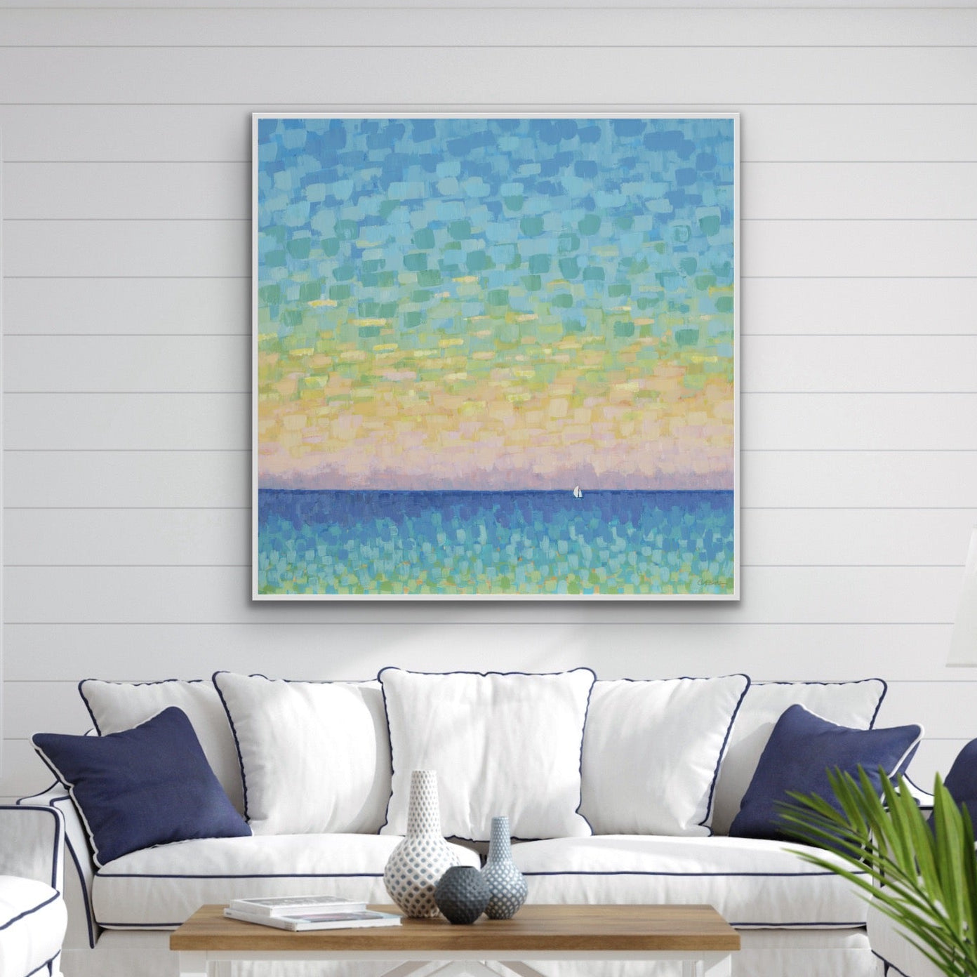Colorful sunset with sailboat art in beach decor room