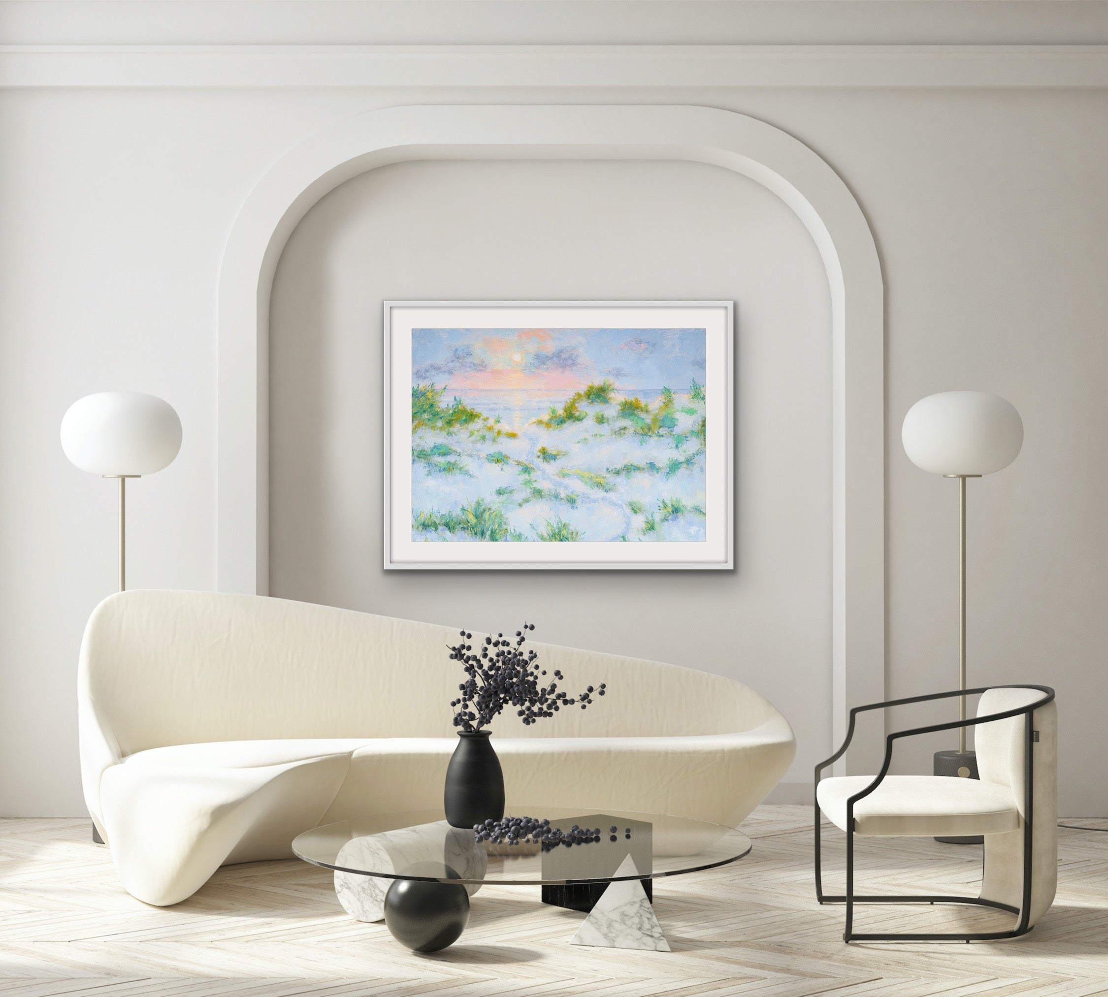 Modern living room with a white sofa, glass coffee table, and Summer Dreams horizontal matted and framed coastal sunrise print on the wall.