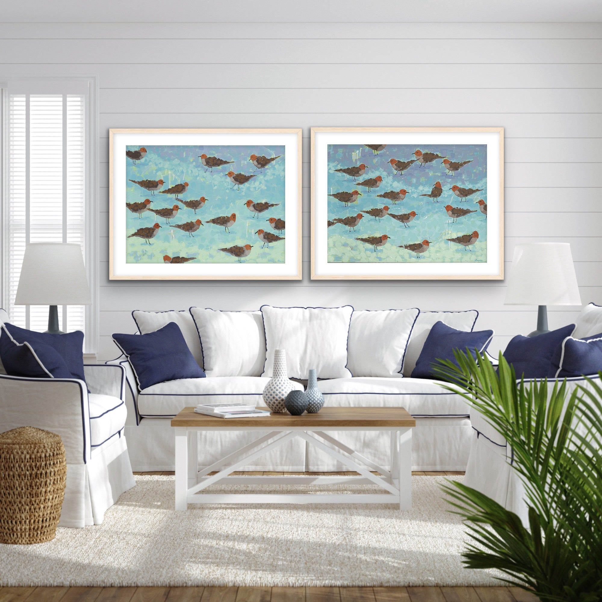  lLuxury giclée diptych of sandpipers by the sea, symbolizing harmony and calmin a living room with a white sofa, wooden and coffee table. 