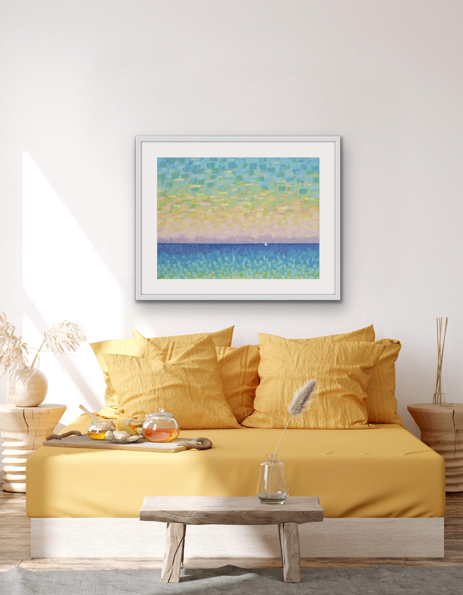 Yellow bedspread on a bed with a framed soft pastel ocean artwork with small white sailboat above, in a room setting.
