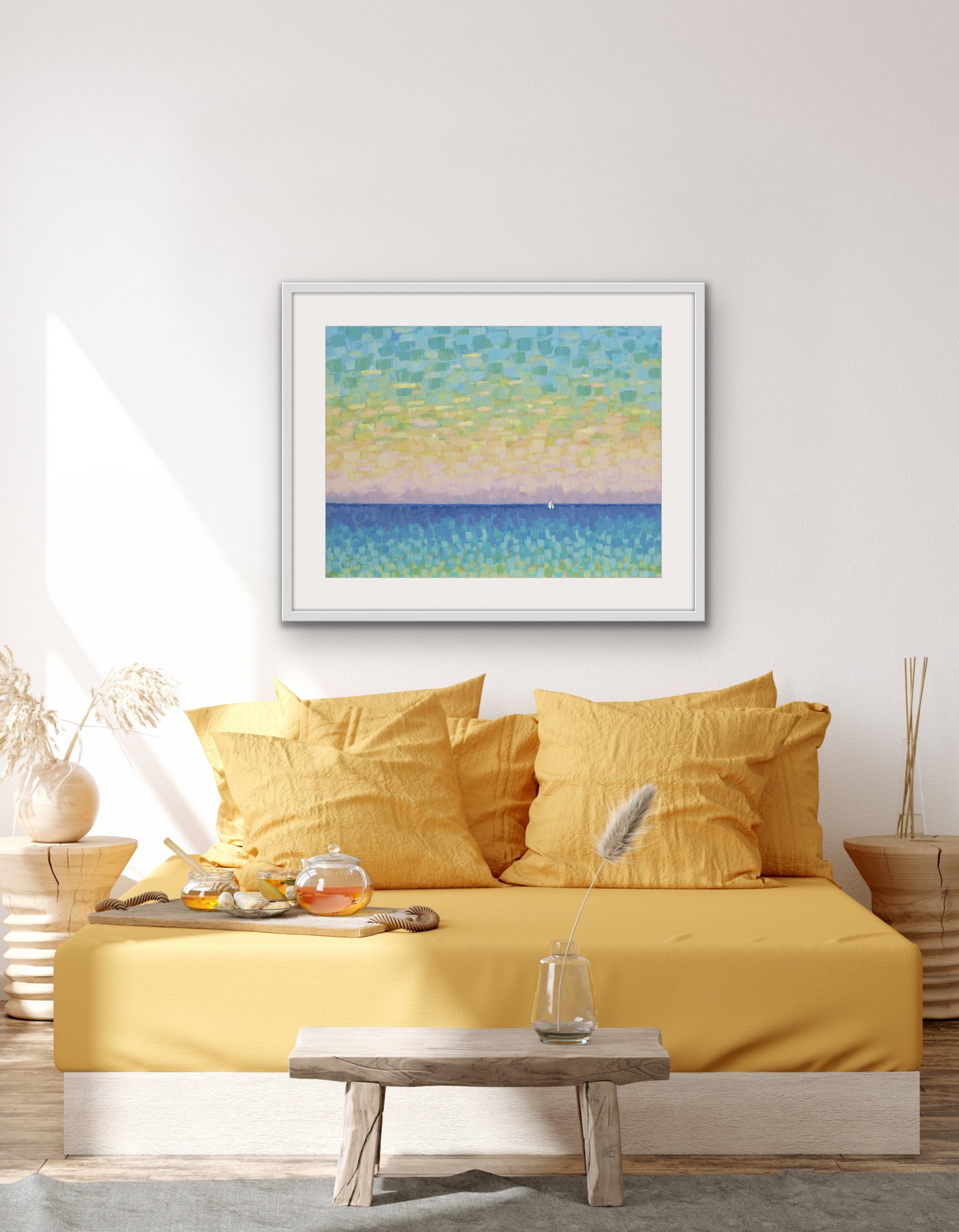 Yellow bedspread on a bed with a framed soft pastel ocean artwork with small white sailboat above, in a room setting.