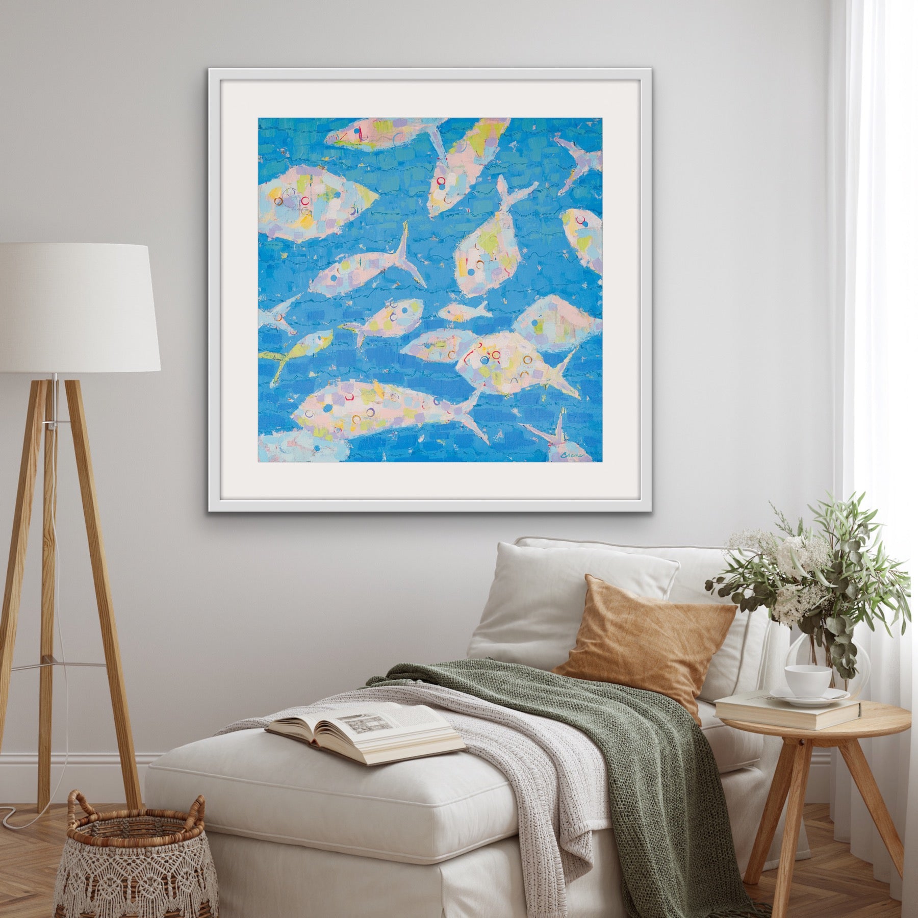 Museum-quality pastel fish art print on a wall above a sofa in a living room.