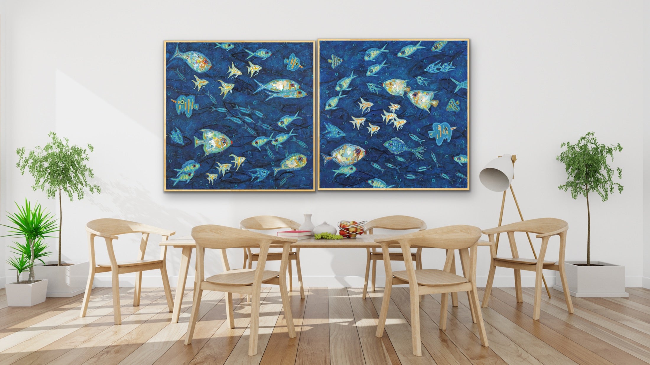 Dining room with a large table and chairs, and  Ocean Gala I & II diptych featuring vibrant coastal fish in deep indigo blues.  