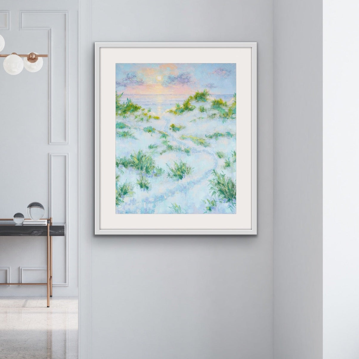 Modern interior with Summer Dreams vertical matted and framed coastal sunrise print framed artwork of a beach scene on a wall.