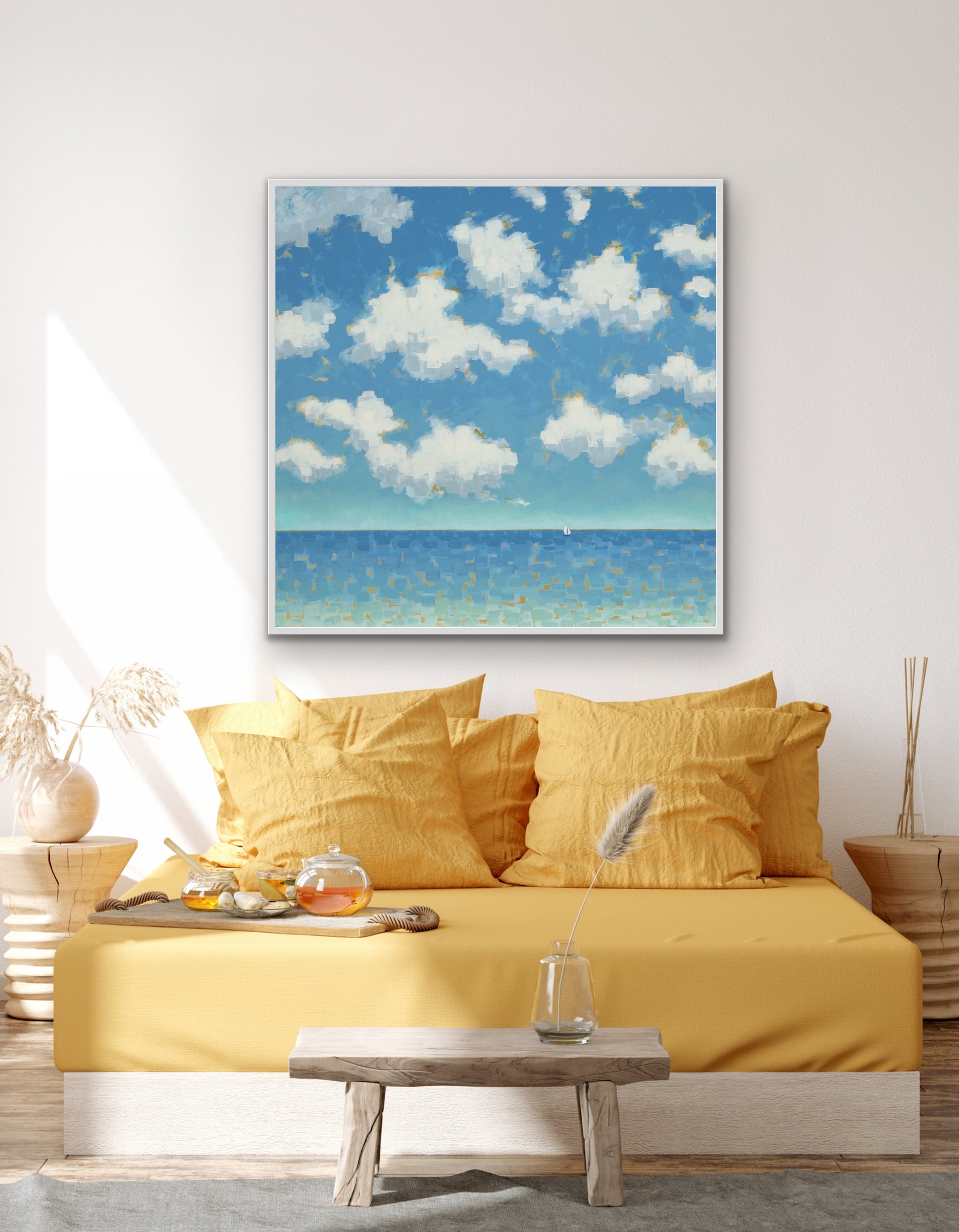 Luxury coastal wall art by Martha Brane featuring sunlit clouds and tranquil blue waters, a modern statement for refined ocean interiors