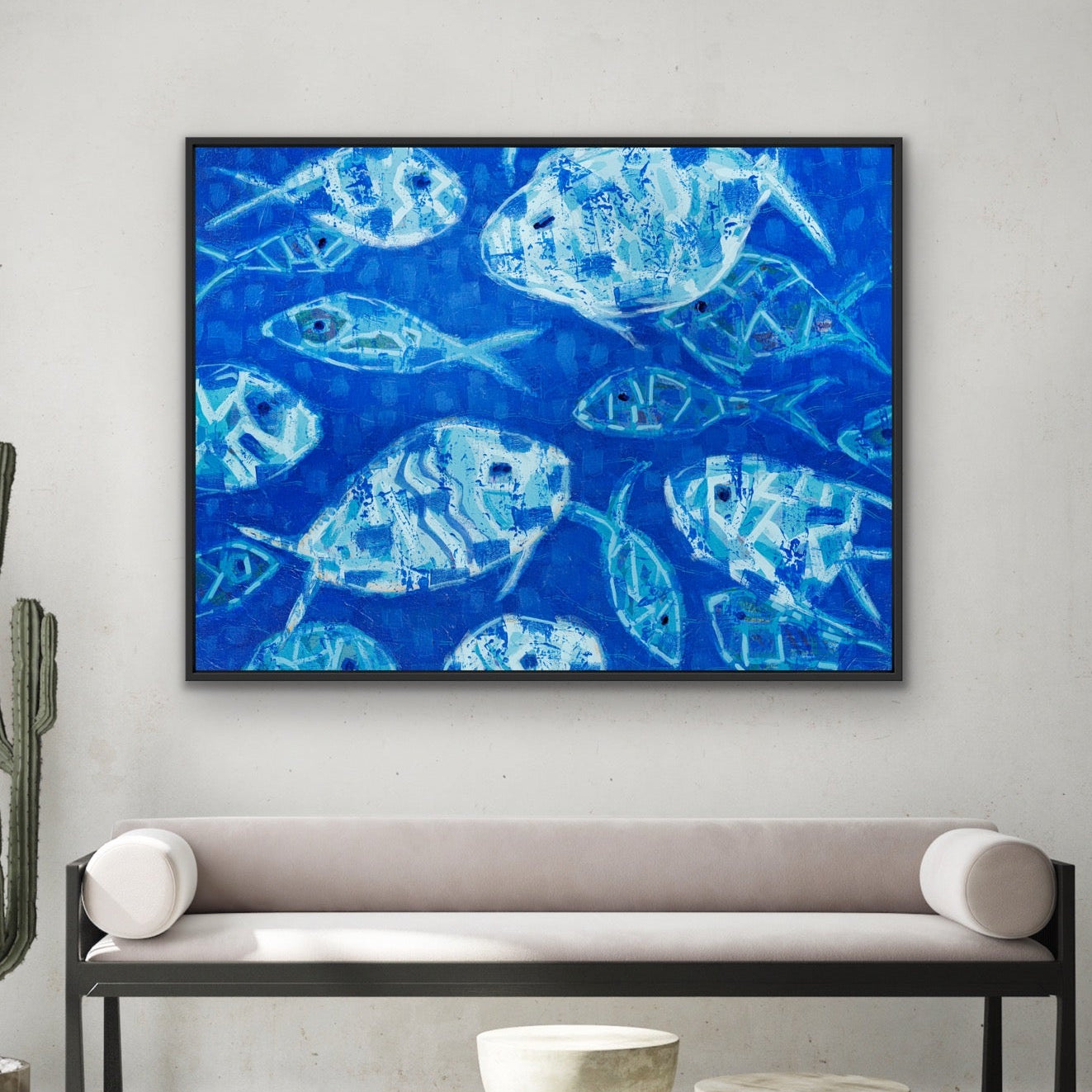 Modern interior with Hooked on Blue horizontal canvas with abstract blue fish by Martha Brane on the wall, a bench, and decorative items.