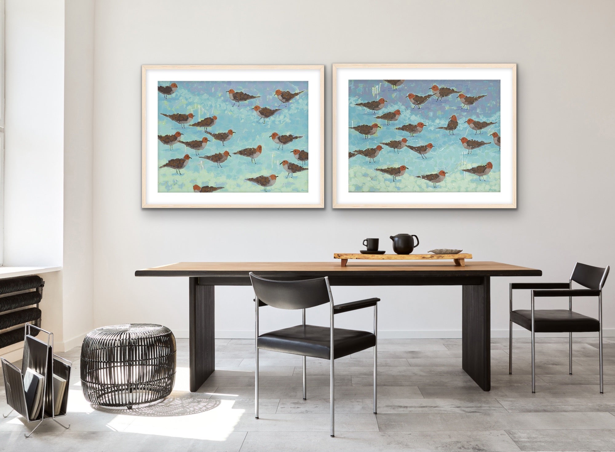 Contemporary coastal wall art set capturing the serene rhythm of the ocean through luminous blue and tan hues in a study with a table and chairs.  