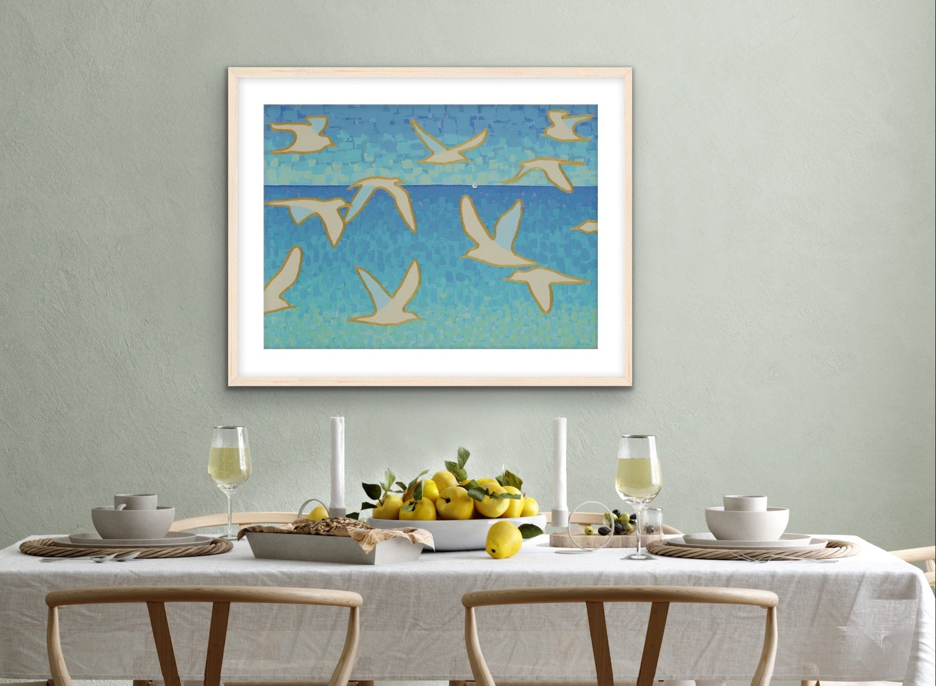 Martha Brane Wings of Light II seagull artwork on canvas, ideal for beach house or ocean-inspired interiors the framed artwork of birds over water in a dining room setting