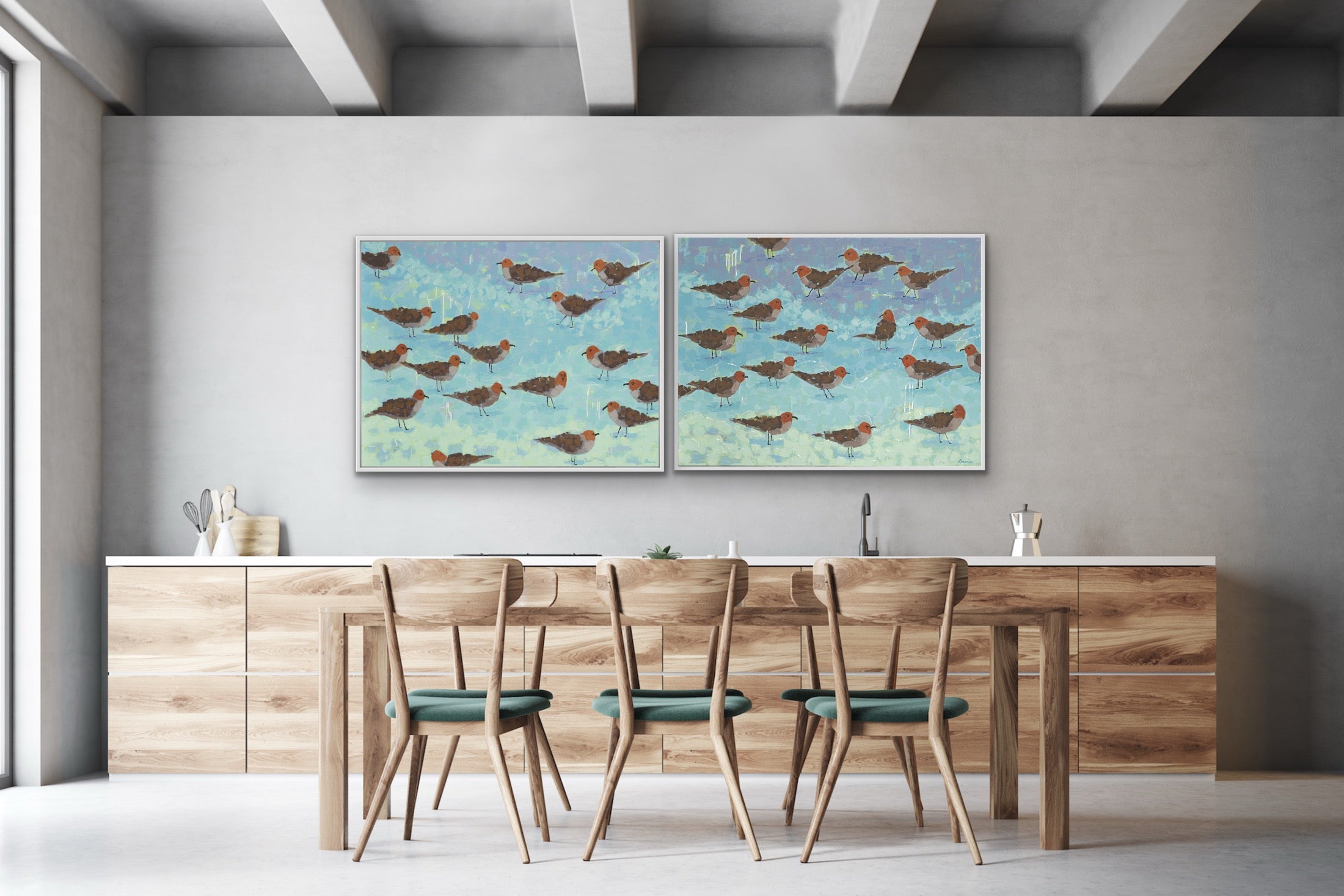 Luxury ocean-inspired giclée canvas pair featuring shorebirds in aqua and seafoam hues in a dining room with wooden table and chairs. 