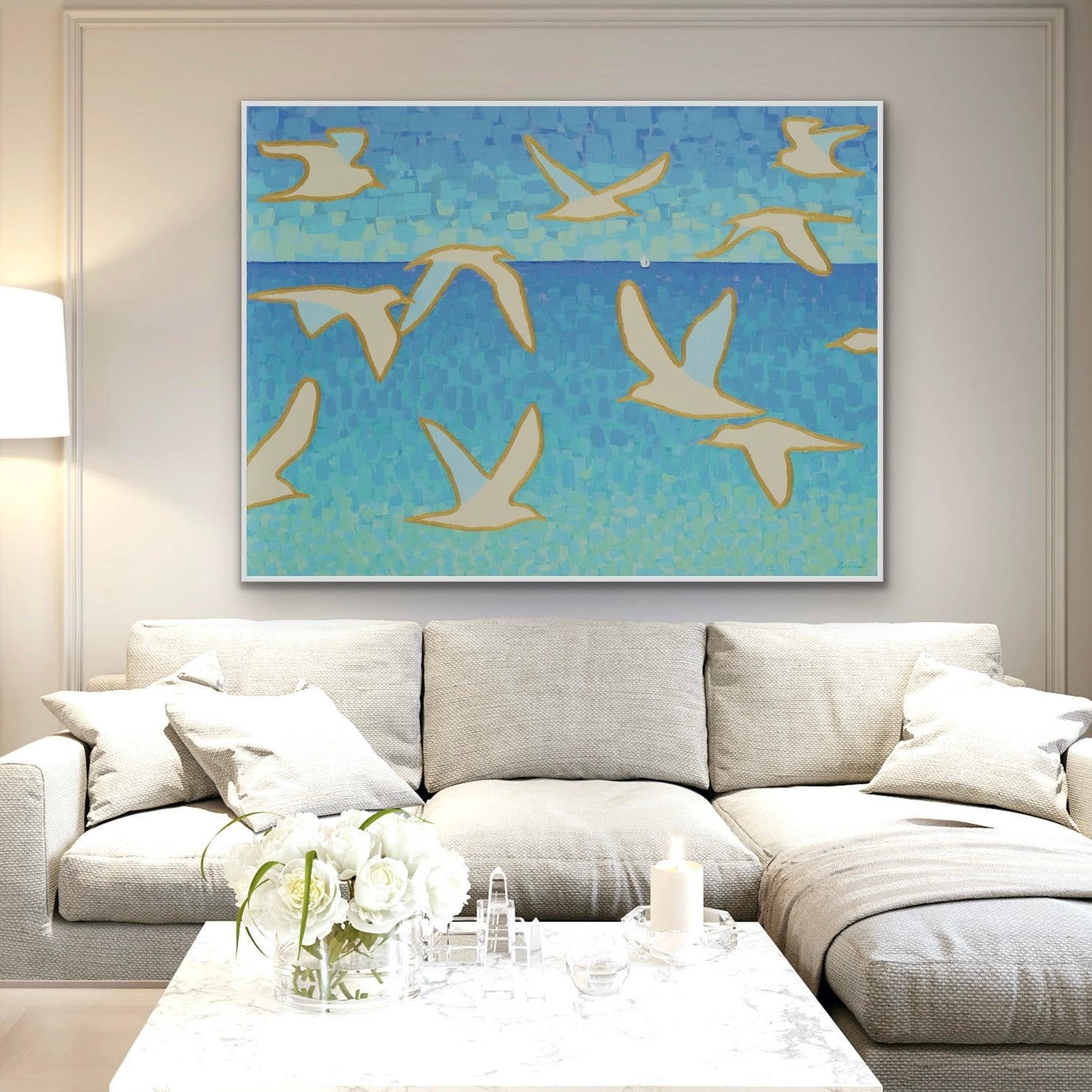 Living room with a gray sofa and a extra large ocean seagull abstract painting on a blue background.