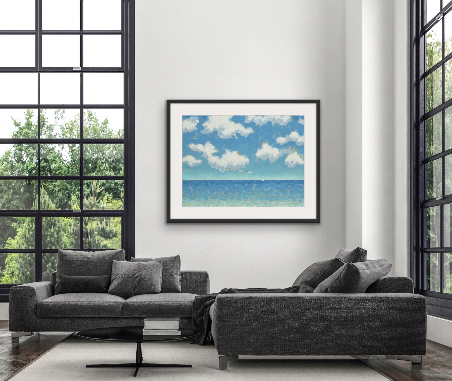 Gray sofa in a modern living room witha matted and framed sailboat art by Martha Brane.