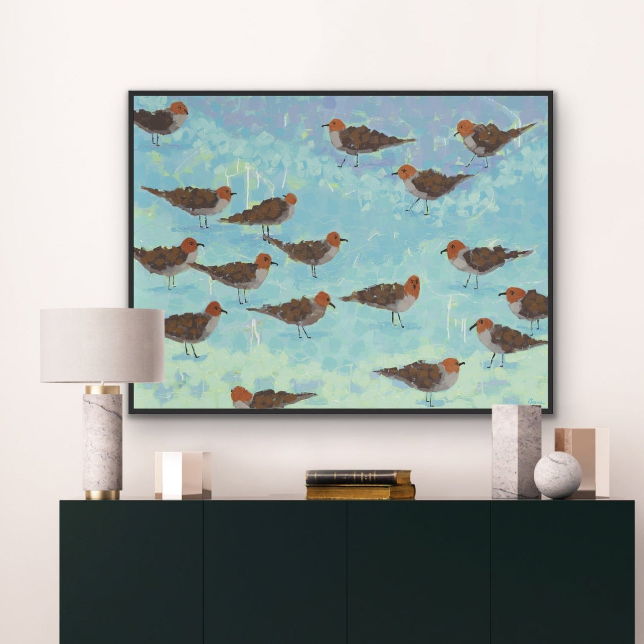 Modern coastal bird art print “Morning Briefing I” framed above a black console in a coastal living room