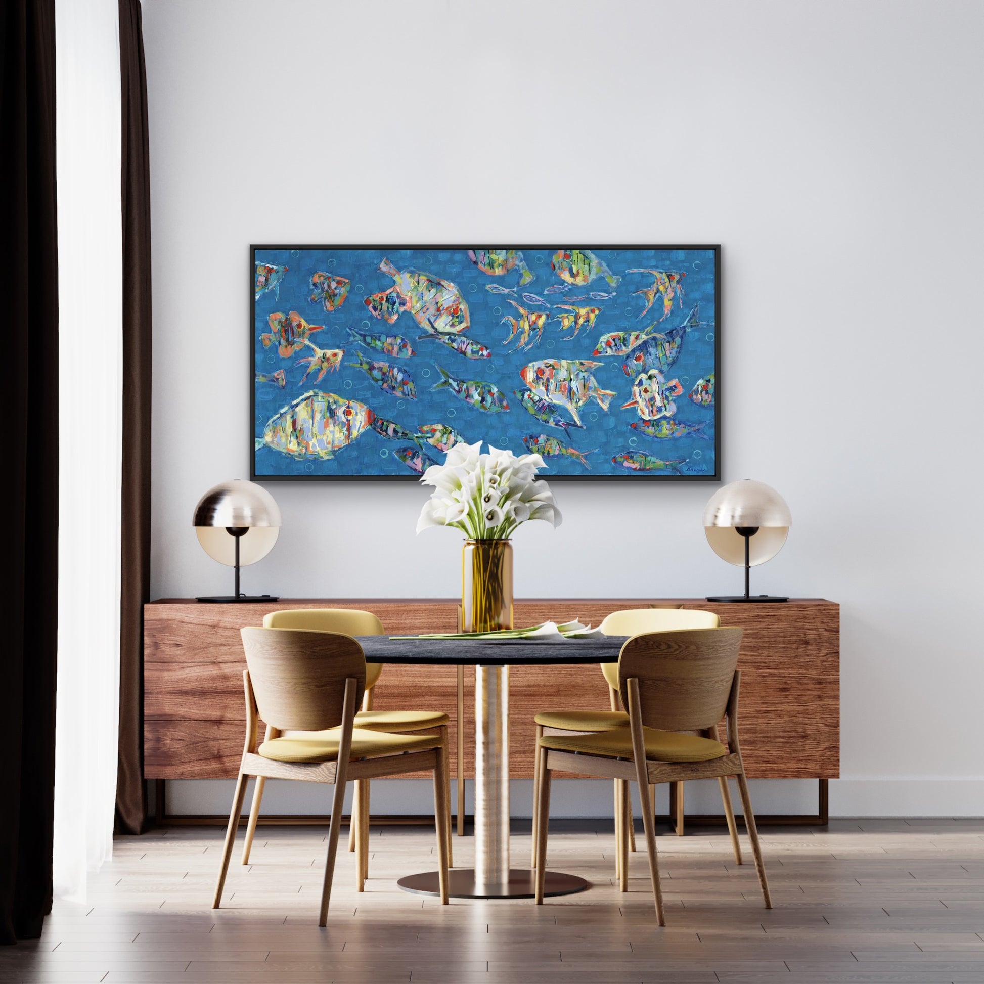 Dining room with a table and chairs, a wooden sideboard, and an original coastal fish painting School Spirit by Martha Brane featuring vibrant color and expressive underwater movement on the wall.
