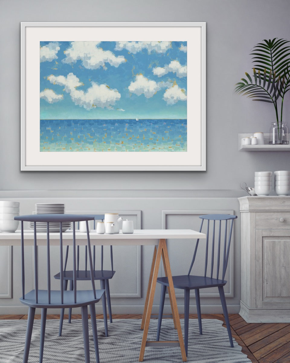 Far and Free horizontal cotton rag seascape framed artwork of a beach scene in a dining room with chairs and a table.