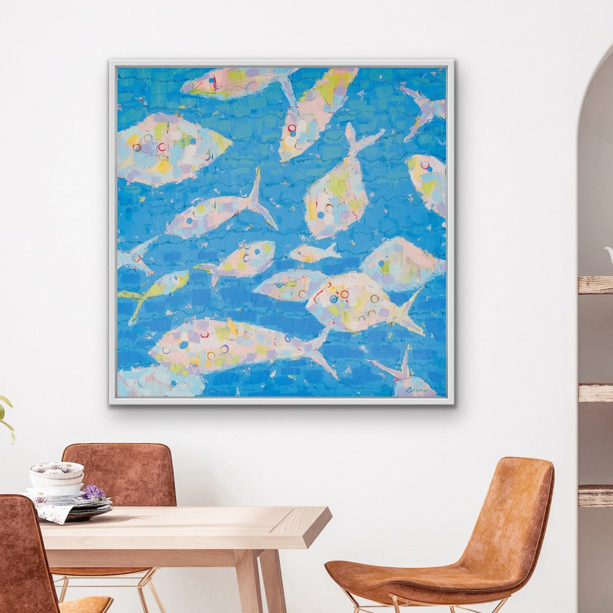 Dining room with a bright coastal fish artwork in soft pink, blue, and yellow tones on the wall