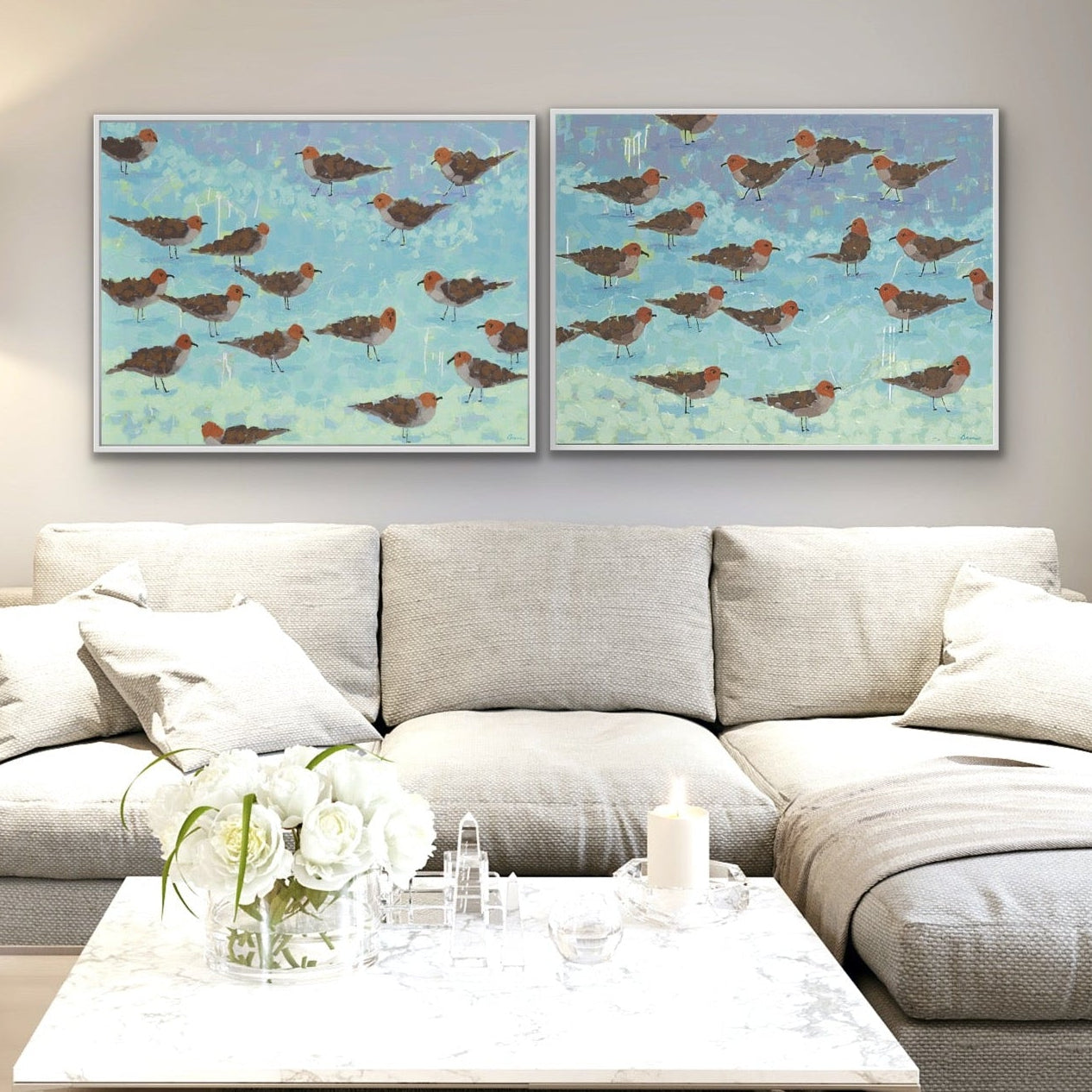 Coastal bird art diptych “Morning Briefing I & II” displayed together in modern living room.   