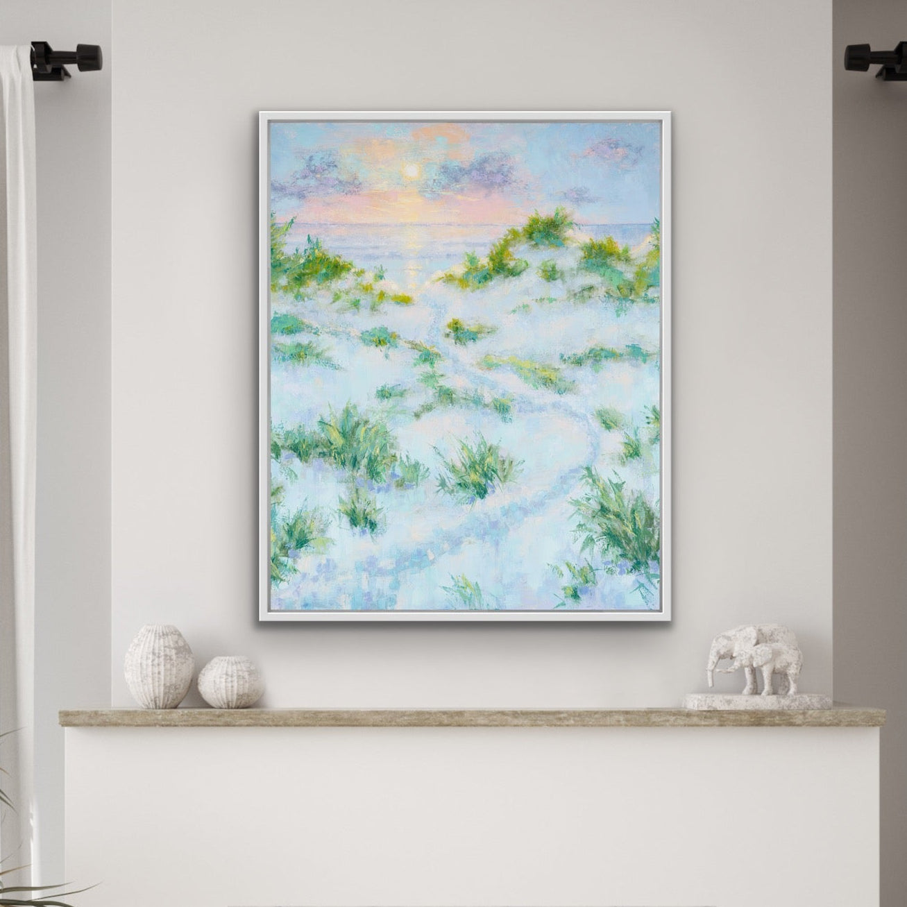 Vertical coastal sunrise canvas print with dunes and pastel sky in a living room with a fireplace.