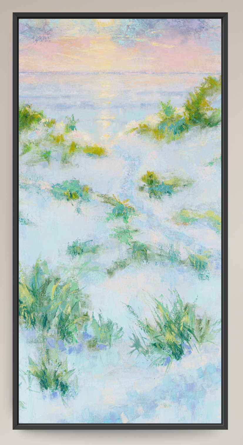 A framed landscape painting depicting a soft, impressionistic coastal scene with pale blue water, green dune vegetation, and a pastel sky in pink, yellow, and blue tones, set in a black frame.