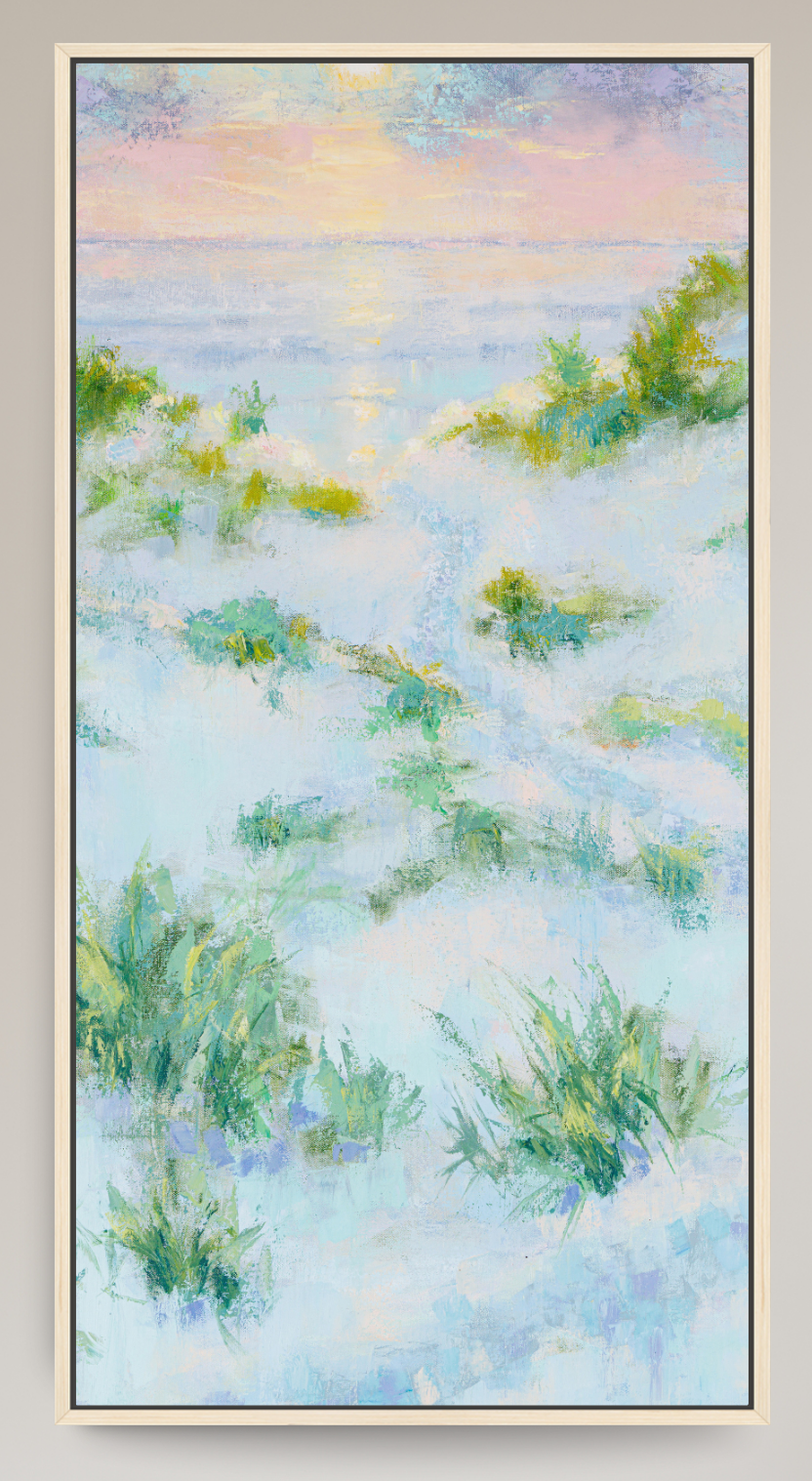 A framed vertical landscape painting depicting a soft, impressionistic coastal scene with pale blue and white water, green grasses, and a pastel sky in pink, yellow, and blue tones.