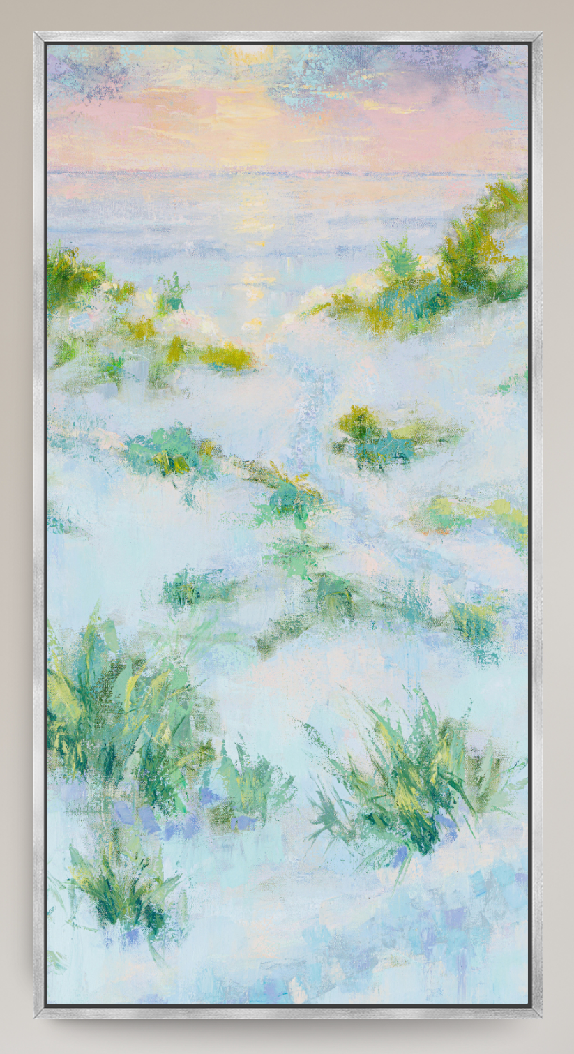 A framed landscape painting depicting a soft, impressionistic beach or dune scene with pale blue and white tones, green vegetation, and a pastel sky with pink, yellow, and lavender hues.