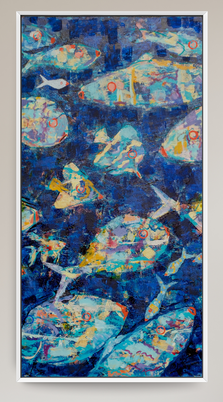 A framed vertical canvas print featuring an abstract painting of fish in deep blue water, styled in a modern living room setting next to a gray armchair and a potted plant.