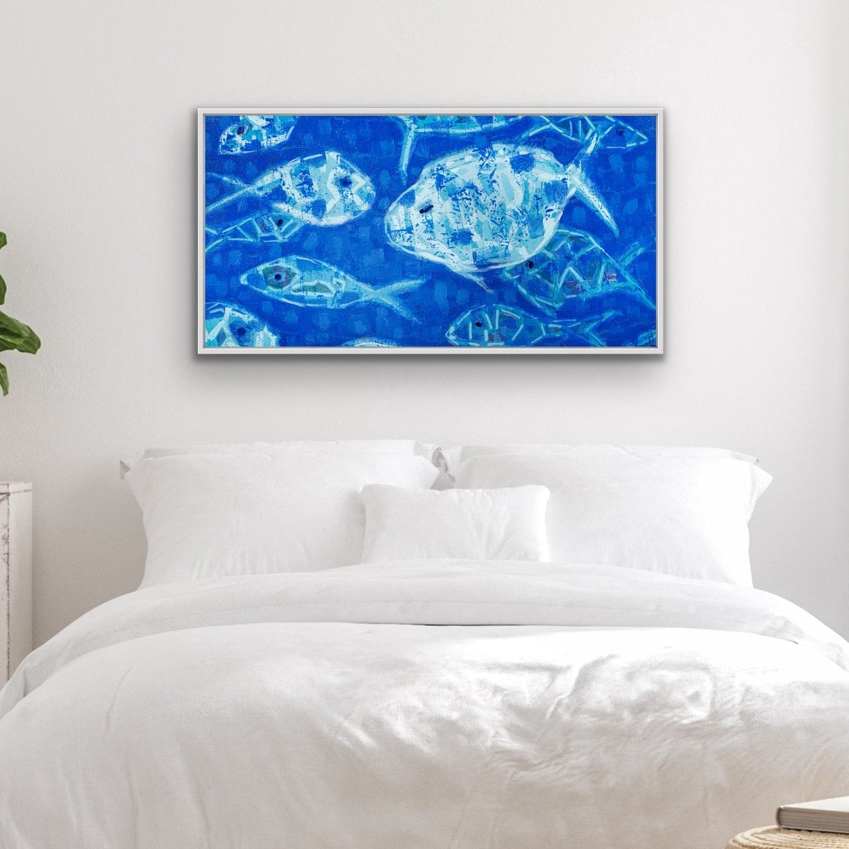 Bedroom with white bedding, a underwater-inspired abstract fish painting in cool blue tones, and decorative plants.