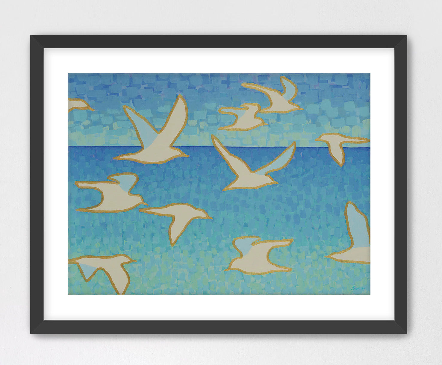 Black framed artwork of seagulls flying over water with a blue sky background.
